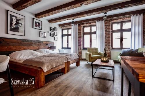 Posteľ alebo postele v izbe v ubytovaní Apartamenty Szewska 25