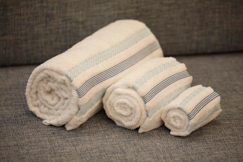 a stack of towels sitting on a couch at LOFT Sá de Noronha in Porto