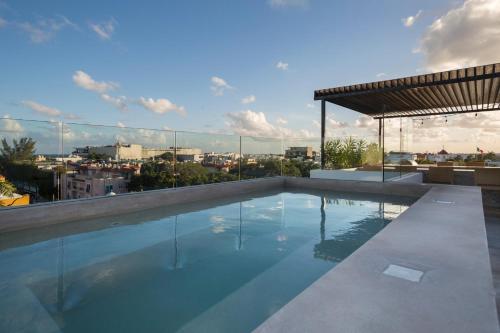 a swimming pool on the roof of a building at Anah Suites in Playa del Carmen