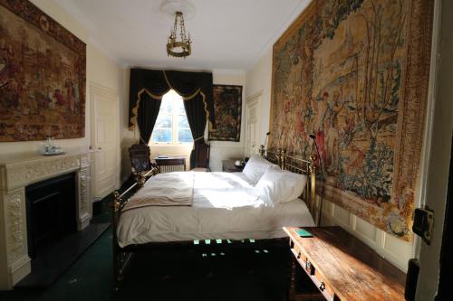 a bedroom with a bed with a tapestry on the wall at Appleby Castle in Appleby