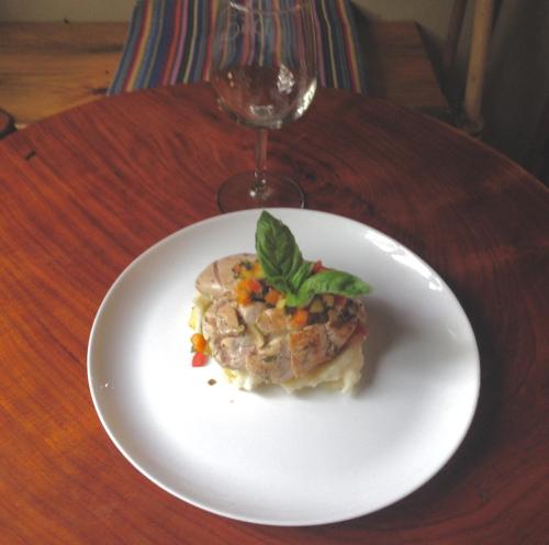 a plate of food on a table with a wine glass at Tierra Alta Ecolodge in Matagalpa