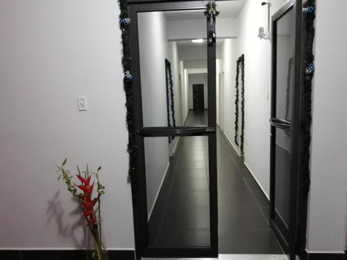 a mirror in a hallway with a long corridor at Waterland Suites in Paramaribo