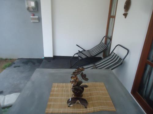 a table with a group of objects on top of it at Sun & Moon Good View Villa in Unawatuna