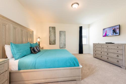 a bedroom with a blue bed and a dresser at New House, Ecolab Sanitzed, Near Disney, Pool Fence in Orlando