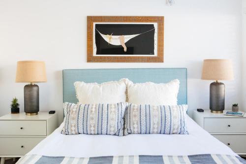 a bedroom with a bed with a blue headboard at Surfhouse in Encinitas