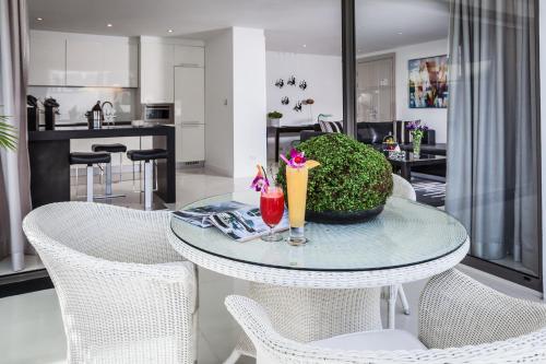 a table with chairs and drinks on it in a kitchen at BYD Lofts - Boutique Hotel & Serviced Apartments - Patong Beach, Phuket in Patong Beach