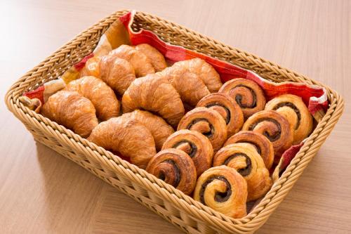 a basket filled with pastries on top of a table at Hotel Route-Inn Koka Minakuchi -Kokudo 1 gou- in Koka