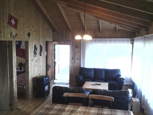 a living room with a couch and a table at Topahue in Ensenada