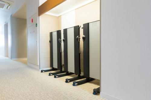 a row of lockers in a hospital hallway at Dormy Inn Matsuyama Natural Hot Spring in Matsuyama
