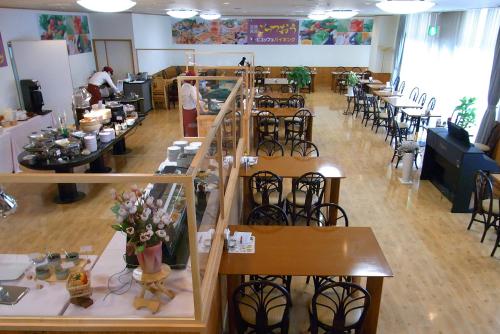 a restaurant with tables and chairs in a room at Kibi Kogen Resort Hotel in Kaga