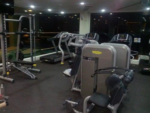 a gym with several exercise bikes and treadmills at The Beverly Hills Hotel in Nakhon Ratchasima