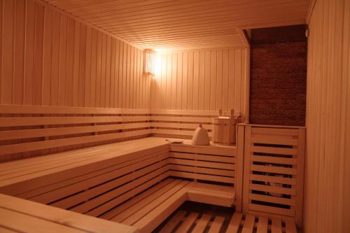 a wooden sauna with a light on top of it at Garden Park Inn in Almaty