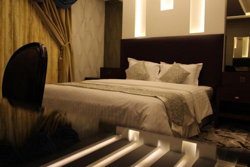 A bed or beds in a room at Sama Hotel