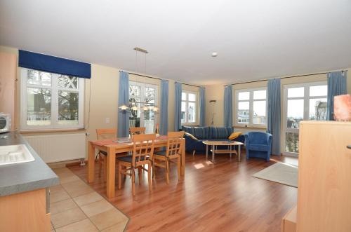 a kitchen and dining room with a table and chairs at Villa Seerose - Appartement 09 in Ostseebad Sellin