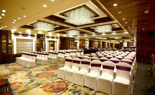 a large room with white chairs in a building at Regenta Central the Crystal Kanpur, in Kānpur