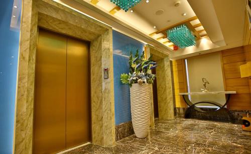 a lobby with a large vase with flowers in it at Regenta Central the Crystal Kanpur, in Kānpur