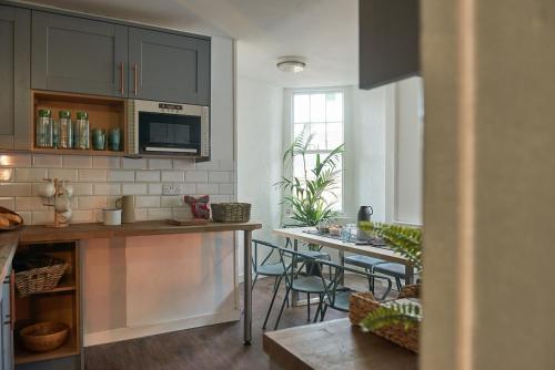 a kitchen with a table and chairs in a room at Haystack Hostel in Edinburgh
