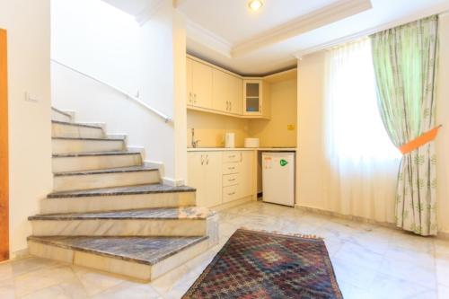 a room with stairs and a kitchen with a window at Orka World Hotel & Aquapark in Oludeniz