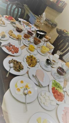 a table with many plates of food on it at Archontiko Petras 1821 in Petra