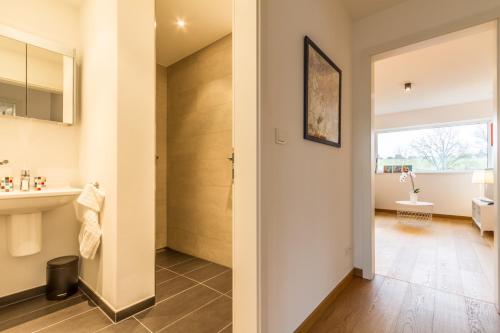 a bathroom with a toilet and a sink and a mirror at stylish flat lux-city in Luxembourg