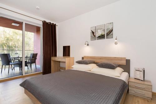 Postel nebo postele na pokoji v ubytování Jantar Apartamenty - Family Vacation Polanki