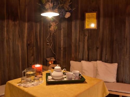 a table with a tea set on top of it at Residence Salvan in Corvara in Badia