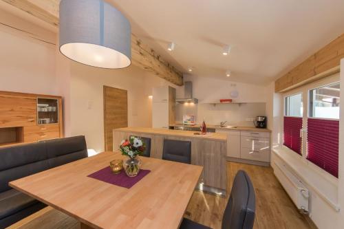 a kitchen and dining room with a wooden table at Ferienhaus Hohenwarter in Lofer
