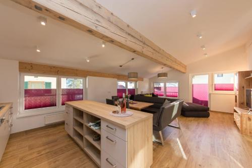 a kitchen and living room with a table and a couch at Ferienhaus Hohenwarter in Lofer