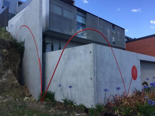 a building with red pipes on the side of it at Quarry House Luxury Retreat in Hobart