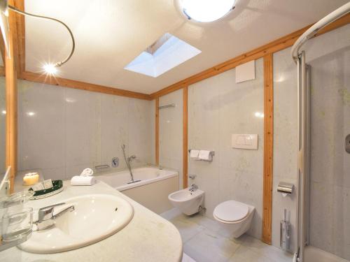 a bathroom with a sink and a toilet and a shower at Residence Salvan in Corvara in Badia