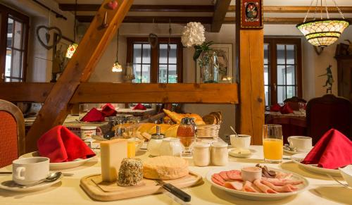 a table with plates of food on top of it at Hostellerie Les Bagenelles in Sainte-Marie-aux-Mines