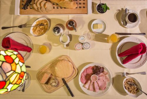 a table with many plates of food on it at Hostellerie Les Bagenelles in Sainte-Marie-aux-Mines