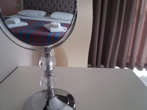 a mirror sitting on a table in front of a bed at Sakura Hostel Fethiye in Fethiye