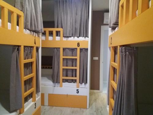 two bunk beds in a room with the names of them at Sakura Hostel Fethiye in Fethiye