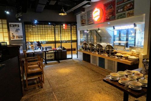a restaurant with a bunch of dishes on a counter at Happy Inn in Jakarta