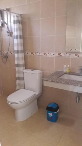 a bathroom with a toilet and a sink at Suksopha Resort in Prachuap Khiri Khan
