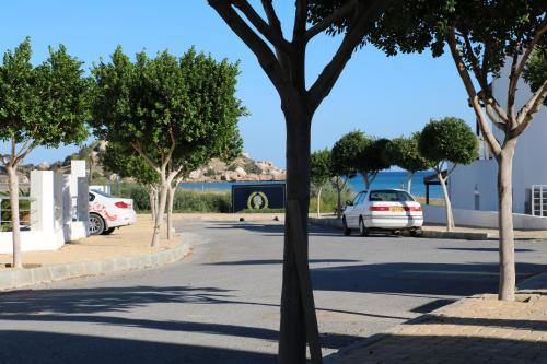 a street with cars parked on the side of the road at Apartment Caesar Beach in Kalecik