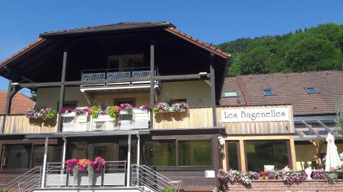 a building with flower boxes and balconies on it at Hostellerie Les Bagenelles in Sainte-Marie-aux-Mines