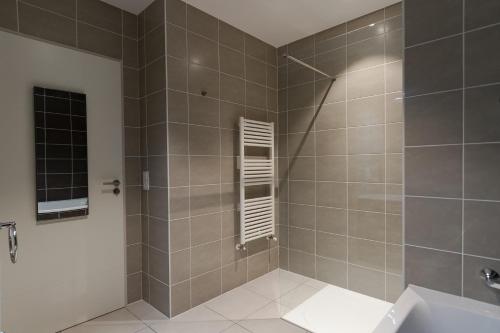 a bathroom with a shower and a sink at La Niche in Brides-les-Bains