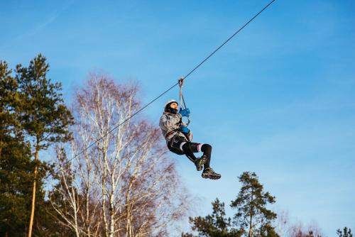 a person on a zip line in the air at Malutkie Resort in Radomsko