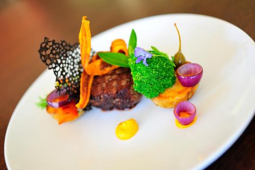 a white plate of food on a table at Malutkie Resort in Radomsko