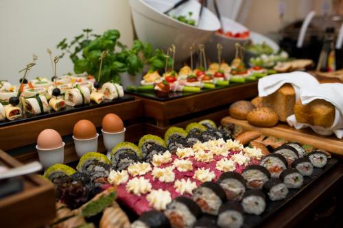 a buffet with many different types of food on display at Hotel & Restauracja Gniecki in Hrubieszów