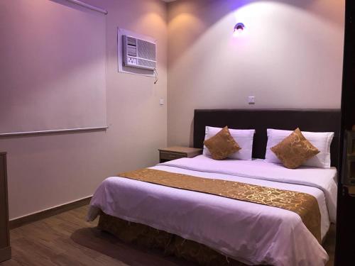 Gulta vai gultas numurā naktsmītnē Dar Al Asalah Hotel-Apartments