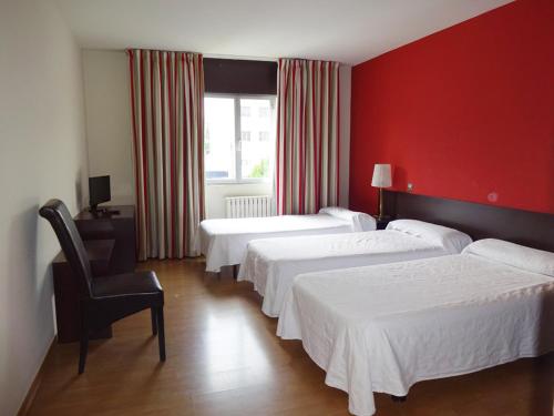 Postel nebo postele na pokoji v ubytování Hotel Millan