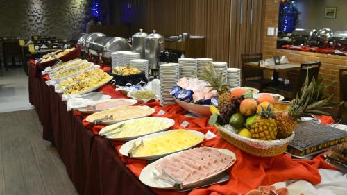 a buffet table filled with lots of different types of food at Hotel Atlântico Rio in Rio de Janeiro