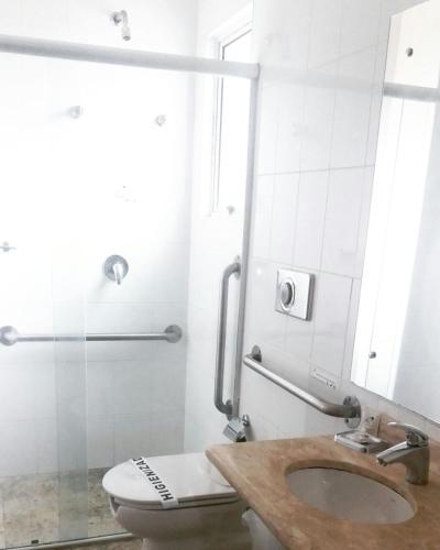a bathroom with a toilet and a sink and a shower at Onix Inn Hotel in Teodoro Sampaio