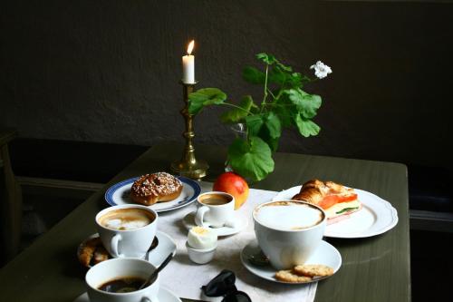 a table with cups of coffee and pastries on it at Hotel Sven Vintappare in Stockholm