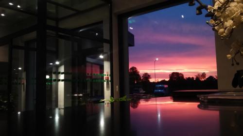 a sunset seen through a window of a building at Restart in Rēzekne