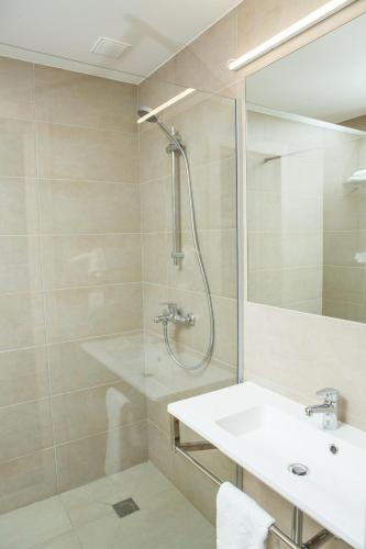 a bathroom with a shower and a sink at Ukraina Hotel in Cherkasy