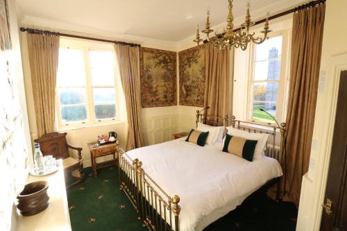 a bedroom with a bed and a chandelier at Appleby Castle in Appleby